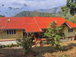 a house with an orange roof on a mountain at Zen homestay in Ravangla