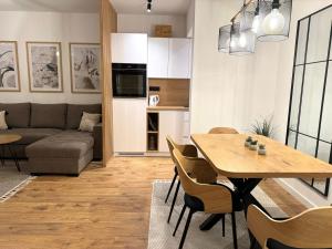 a living room with a table and a couch at PineTree Jahorina in Jahorina