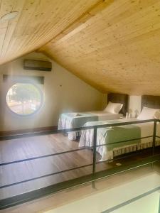 two beds in a room with a window at Casa das Varzielas in Mondim de Basto