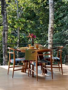 a wooden table and chairs on a deck at Monkey House in Dominicalito