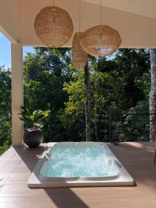 a jacuzzi tub on a deck with two lights at Monkey House in Dominicalito