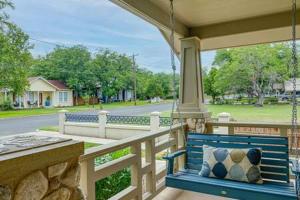a blue bench on the porch of a house at The Mint Julep, pet-friendly, hot tub, sleeps 8! in Fredericksburg