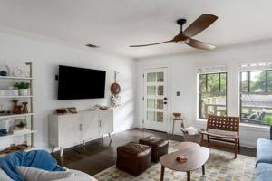 a living room with a flat screen tv on the wall at The Mint Julep, pet-friendly, hot tub, sleeps 8! in Fredericksburg +48 photos