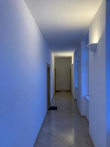um corredor vazio com paredes azuis e um tecto em SEA-DWELLER APARTMENT em Balatonfüred