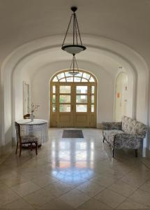 a large room with a table and chairs and a chandelier at SEA-DWELLER APARTMENT in Balatonfüred