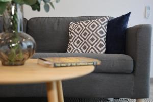 a book on a table next to a couch at Bright 2 Bedroom 2 Bath Apartment close to sea in St Paul's Bay