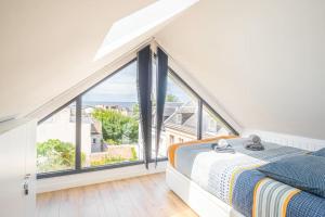 a bedroom with a large window and a bed at L'appel du Large - Plage - Vue mer in Sainte-Adresse