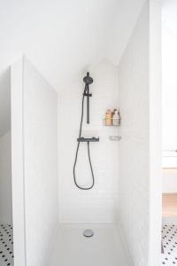 a white bathroom with a shower with a toilet at L'appel du Large - Plage - Vue mer in Sainte-Adresse