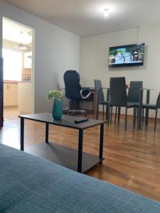 a room with a table with chairs and a tv at Miraflores Moonlight in Lima