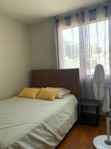 a bedroom with a bed with two pillows and a fan at Costa Verde 2 Bedrooms Apartment Miraflores in Lima