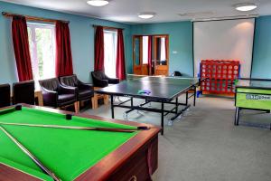 a billiard room with a pool table and chairs at YHA Borrowdale in Rosthwaite