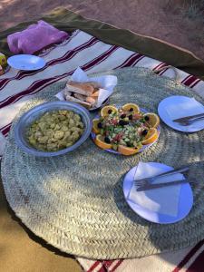 a table with plates of food on top at Casa Familia in Zagora