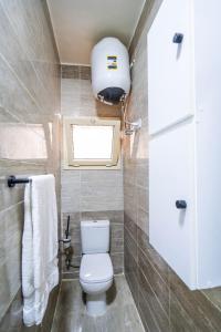 a small bathroom with a toilet and a window at Hurghada apartment luxury 001 in Hurghada +2 photos