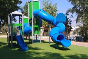 a playground with a blue slide in a park at Kosher 'Villa Rosa' Moshav Aderet, Ella Valley nr Bet Shemesh in Adderet
