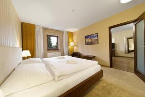 a large white bed in a hotel room at Pilsner Apartments - U Borského parku in Plzeň