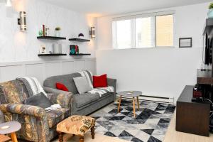a living room with a couch and a table at condo sainte-anne in Beaupré