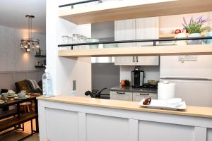 a kitchen with white cabinets and a counter top at condo sainte-anne in Beaupré