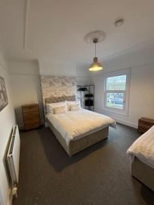 a bedroom with a bed and a window at Cosy 3 Bed Cleethorpes retreat in Cleethorpes