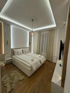 a bedroom with a large white bed in a room at Mona Luxury Apartments - Free Garage Parking in Sarajevo