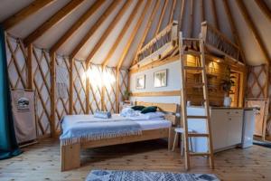 a bedroom with a bunk bed in a tent at Mononoke -Jurty nad Sanem in Lutowiska