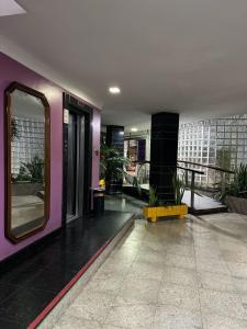 a lobby of a building with a mirror on the wall at Hotel Novo Plano in Salvador