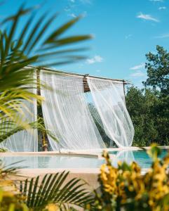 a white net in front of a swimming pool at Casa Noma-Noma Holbox in Holbox Island