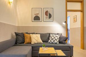 a living room with a gray couch and a table at Modern spacious apartment central of Seville in Seville +21 photos