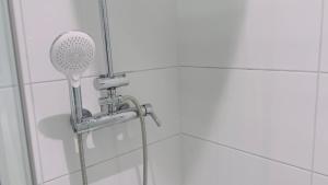 a shower with a shower head in a bathroom at Familienfreundlich - Eleganz im Hunsrück, nahe Mosel in Morbach