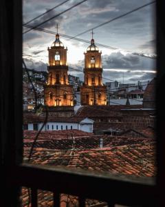 two towers with a clock on them in a city at THIS IS COLOMBIA HOSTEL in San Gil