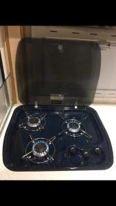 a blue stove top oven sitting in a kitchen at Autocaravana Lisboa in Frielas