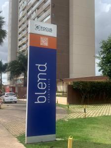 a sign in the grass in front of a building at 902. Flat Blend - Proibido fumar in Brasilia