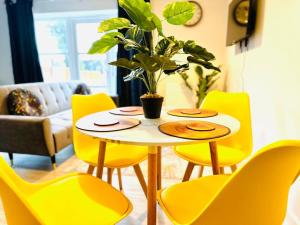 a yellow table and chairs in a living room at Cosy Dover suite w Free Parking in Kent