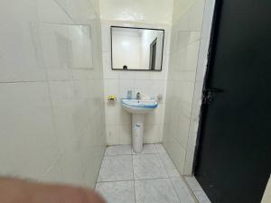 a bathroom with a sink and a mirror at Studio parfaitement confortable in Nouakchott