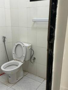 a bathroom with a toilet with the lid up at Studio parfaitement confortable in Nouakchott