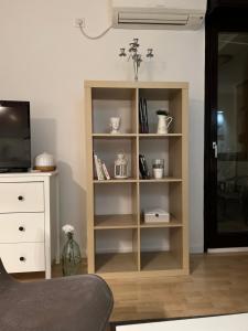 a book shelf in a living room with a tv at Rocco Apartment-FREE PARKING&WIFI in Zagreb