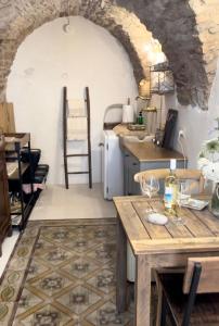 a kitchen with a table and a counter top at DOMMO ASULETTA in Bosa