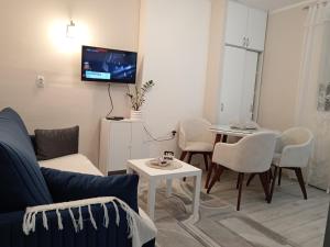 a living room with a couch and a table at Red Square Apartment in Pirot