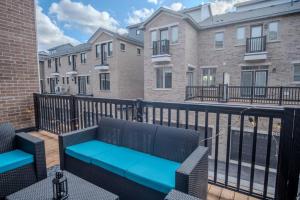a balcony with two benches and some buildings at Modern 4-Bed Townhome with Cinema & Roof Terrace in Oakville