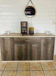 a room with a wooden counter with a mirror at Villa Réséda in Sainte-Anne