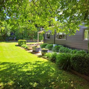 a yard with plants and a house at The Homestead in Taupo