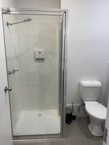 een badkamer met een douche en een toilet bij Longreach Motor Inn in Longreach