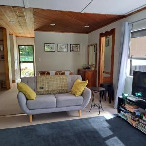 a living room with a couch and a television at The Homestead in Taupo