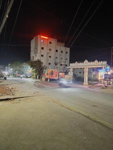 a car driving down a city street at night at Hotel KP Suites Airport in Shamshabad