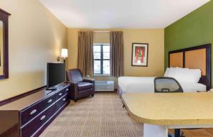 a hotel room with two beds and a flat screen tv at Extended Stay America Suites - Albany - SUNY in Albany