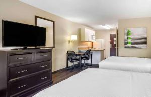 a hotel room with a bed and a flat screen tv at Extended Stay America Suites - Philadelphia - Bensalem in Bensalem