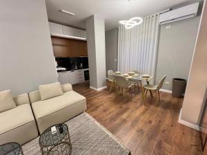 a living room with a couch and a table at Durres Lovely Apartment in Durrës