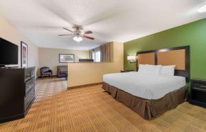 a hotel room with a bed and a flat screen tv at Extended Stay America Suites - Minneapolis - Airport - Eagan - South in Eagan