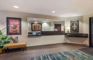 a lobby with a waiting area with a bench and a mirror at Extended Stay America Select Suites - Chicago - Lisle in Lisle