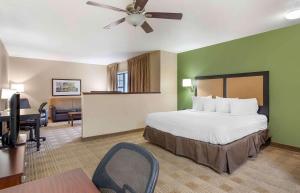 a large hotel room with a bed and a desk at Extended Stay America Select Suites - Chicago - Lisle in Lisle