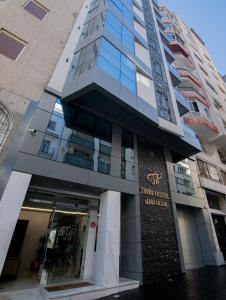 a building with the front entrance to a hotel at Twin Hotel Tanger in Tangier